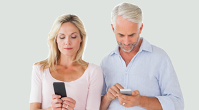 Auburn couple using smartphones