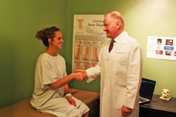 Image of chiropractor meeting with young patient
